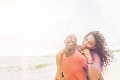 Young couple playing on beach