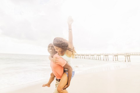 Young couple playing on beach