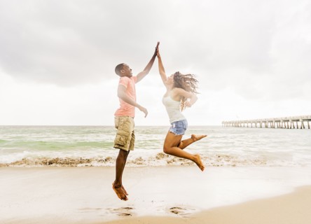 Young couple playing on beach