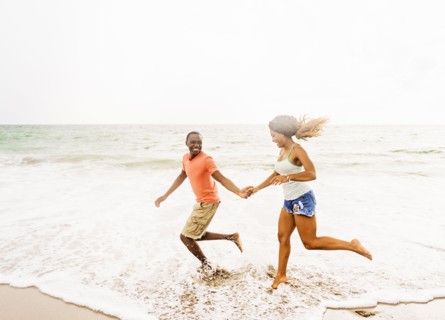 Young couple running on beach