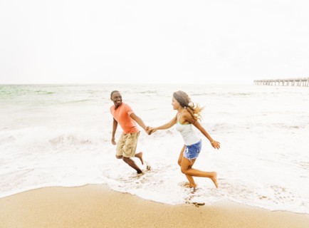 Young couple running on beach