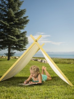 Girl (2-3) lying in tent