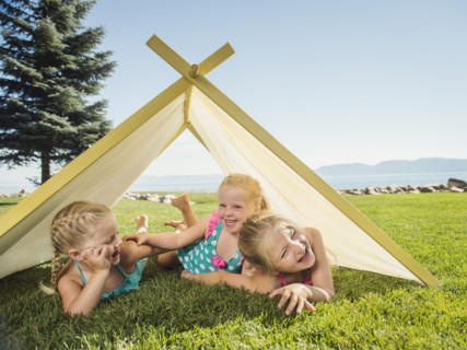 Three girls (2-3, 4-5) playing in tent