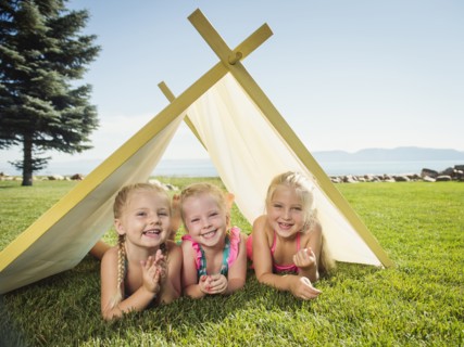 Three girls (2-3, 4-5) playing in tent