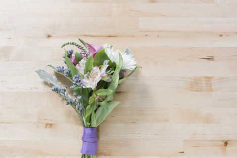 Studio shot of bunch of flowers against wooden surface