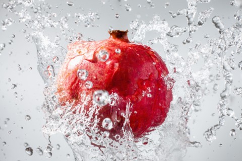 Droplets splashing on pomegranate