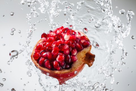 Droplets splashing on pomegranate