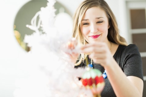Young woman holding Christmas ornament