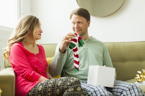 Man holding unwanted Christmas gift