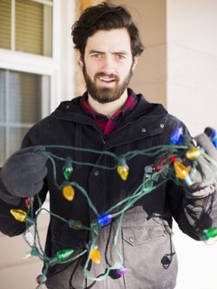 Front view portrait of young man with Christmas light
