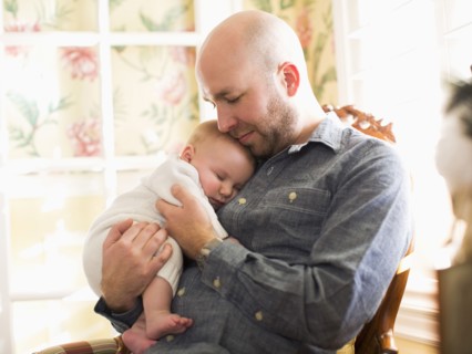 Mid adult man watching his son (2-5 months) sleeping