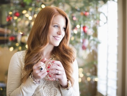 Mid adult woman with coffee mug in christmas time