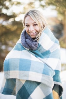 Portrait of woman wrapped in blanket standing outdoors