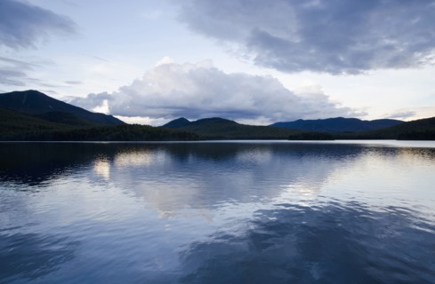 Clouds reflecting in lake at dusk