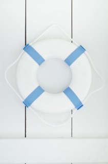 White lifebelt hanging on white wall