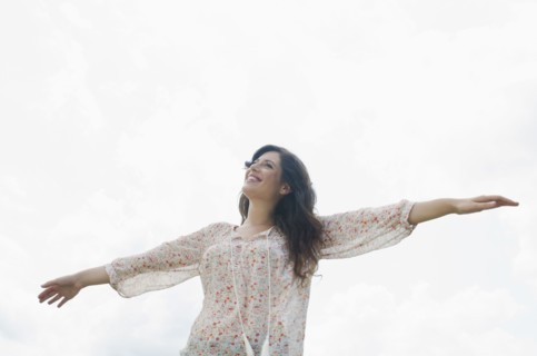 Happy woman against sky