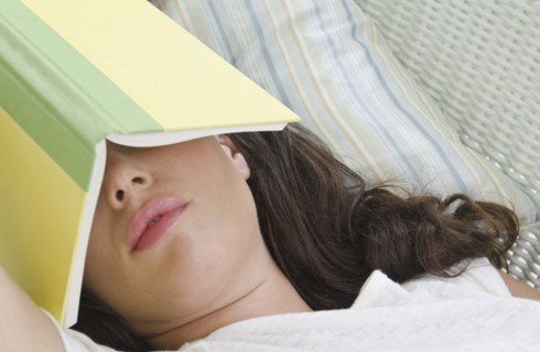 Woman sleeping with book on face