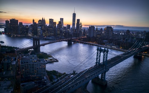 Aerial view of city with Freedom tower at sunset. New York City, New York.