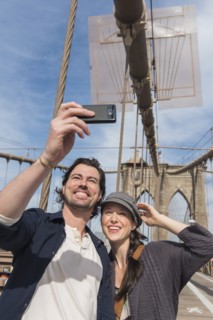 Happy couple taking selfie on Brooklyn Bridge. Brooklyn, New York.
