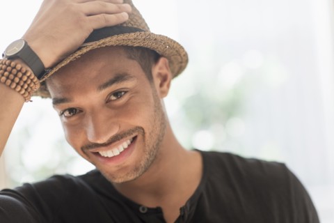 Portrait of smiling man in straw hat.