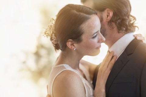 Bride and groom dancing cheek to cheek.