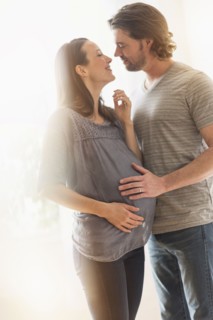 Happy man and his pregnant woman.