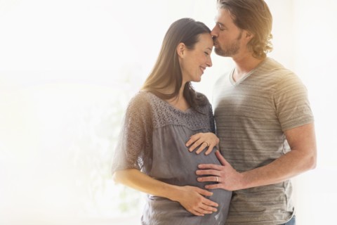 Man kissing pregnant woman.