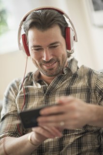 Smiling man listening to music. .