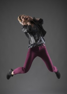 Studio shot of woman jumping.