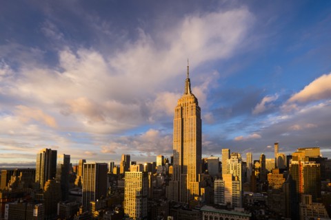Cityscape with Empire State Building at sunset. New York City, New York.