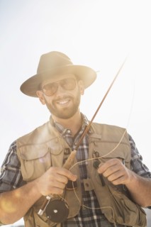Portrait of man holding fishing rod.