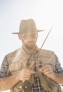 Portrait of man holding fishing rod.