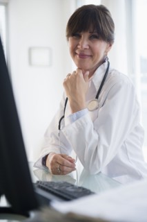 Portrait of doctor sitting at desk