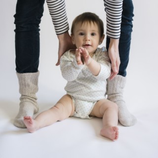 Portrait of cute baby girl (12-17 months) with her mom