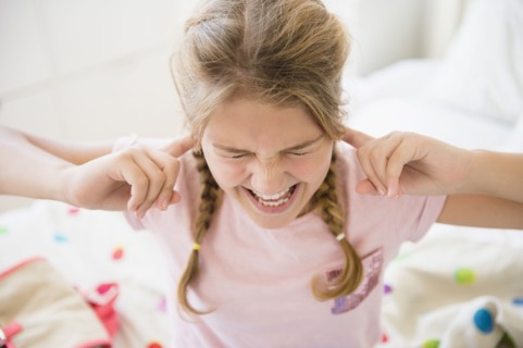 Angry girl (12-13) in bedroom