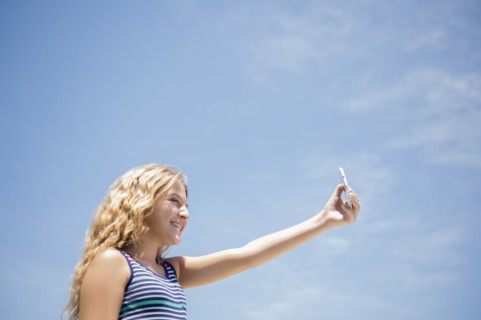 Girl (12-13) taking selfie