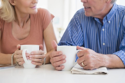 Cropped shot of husband and wife drinking coffee and talking