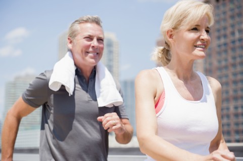 Portrait of couple jogging in city