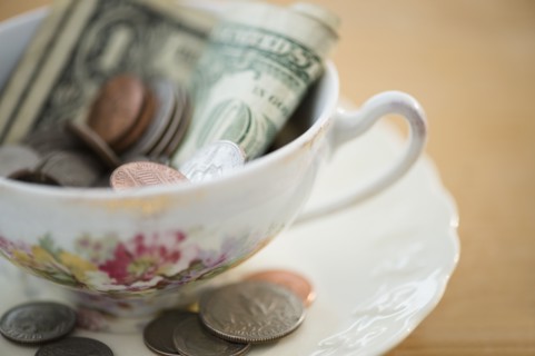 Studio shot of money in tea cup