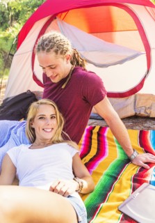 Couple resting in front of tent