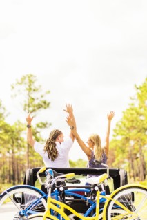 Couple rising hands in car