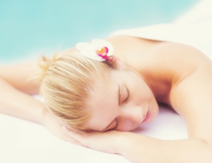 Woman lying next to swimming pool