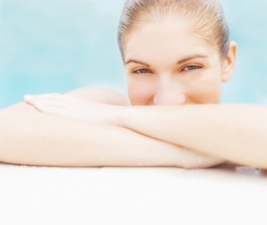 Portrait of woman on edge of swimming pool