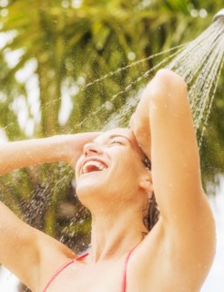 Woman taking shower outdoors