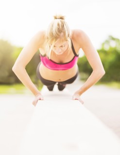 Woman doing pushups outdoors