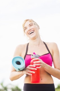 Portrait of smiling woman drinking water