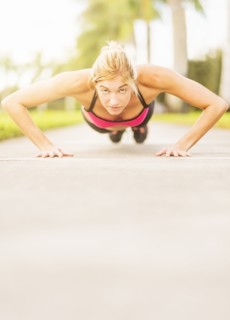 Woman doing pushups outdoors