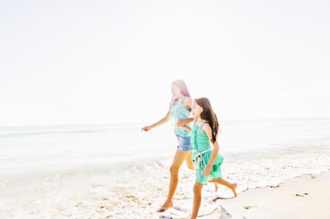 Mom and daughter (6-7) spending time together on beach