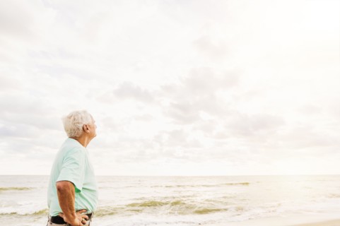 Side view of senior man standing on beach