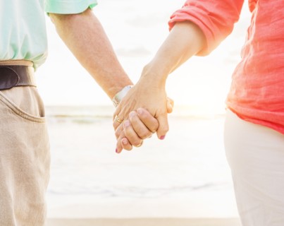 Couple holding hands on beach